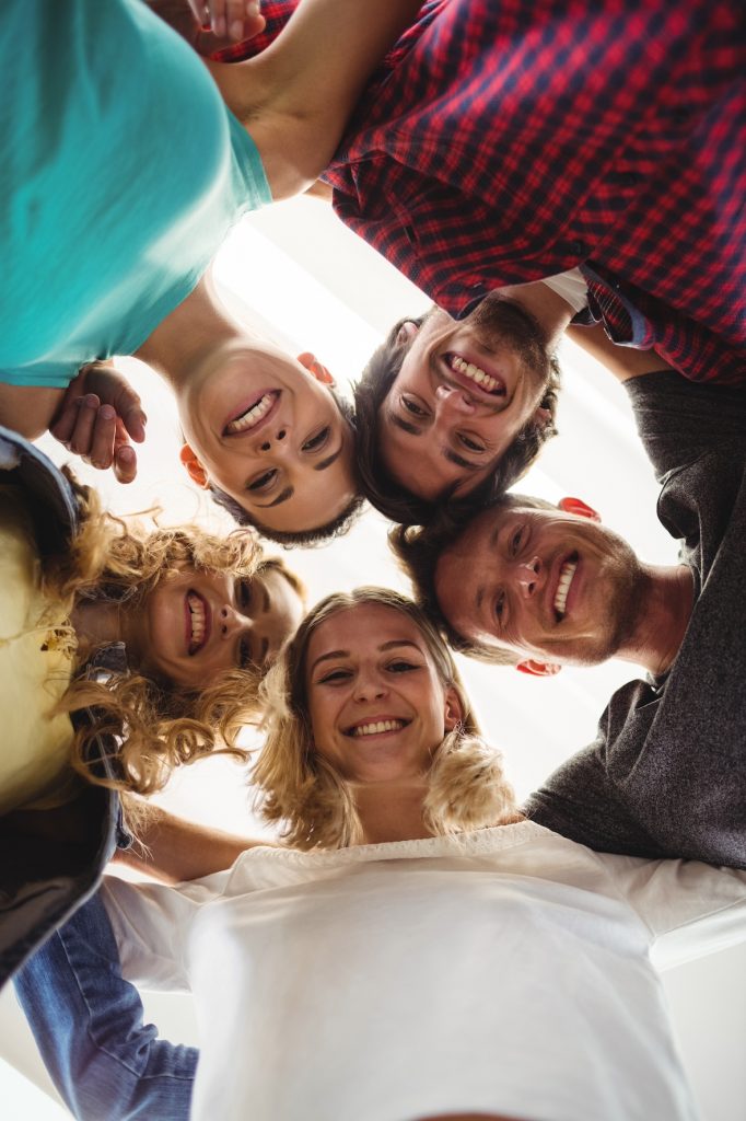 group of business executives forming huddle